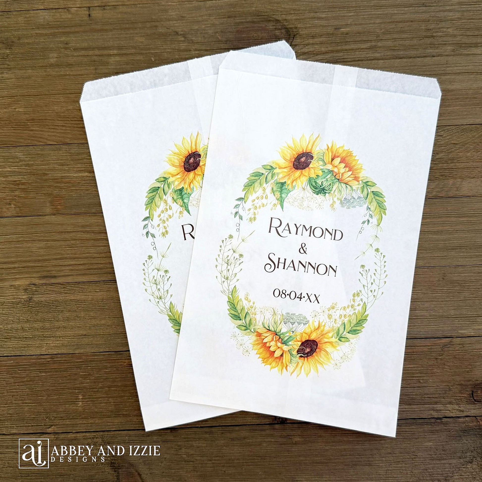Sunflower Wedding Favor Bags that are personalized for the bride and groom.  Adorned with a sunflower wreath around the names and wedding date.  