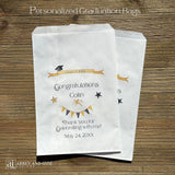 Personalized graduation party bags printed on white bags with the graduates name and event date.  Adorned with black and gold stars, flags and grad cap these will be perfect for candy, cookies or utensil bags.