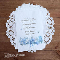 Personalized blue hydrangea bridal shower favors bags, perfect for a small gift of appreciation or a cookie bar or even a candy bar.  White bags adorned with delicate blue hydrangeas for a sweet addition to your event.