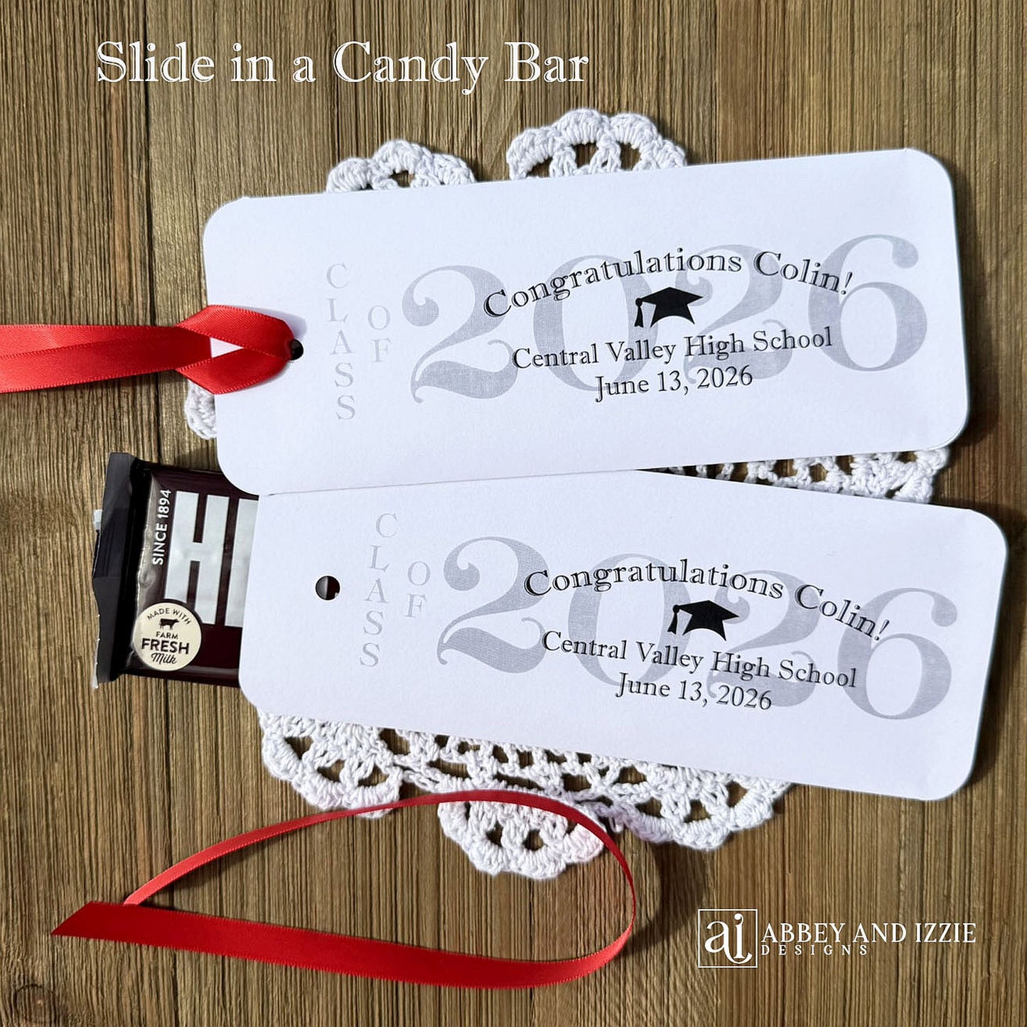 Graduation Candy Bar Favors personalized for the graduate. Printed on white card stock, choice of ribbon color.  Class of year printed in large font and congratulations to the guest of honor with school name and event date.  Just slide a candy bar in the open end and tie the ribbon on.