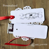 Graduation Candy Bar Favors personalized for the graduate. Printed on white card stock, choice of ribbon color.  Class of year printed in large font and congratulations to the guest of honor with school name and event date.  Just slide a candy bar in the open end and tie the ribbon on.