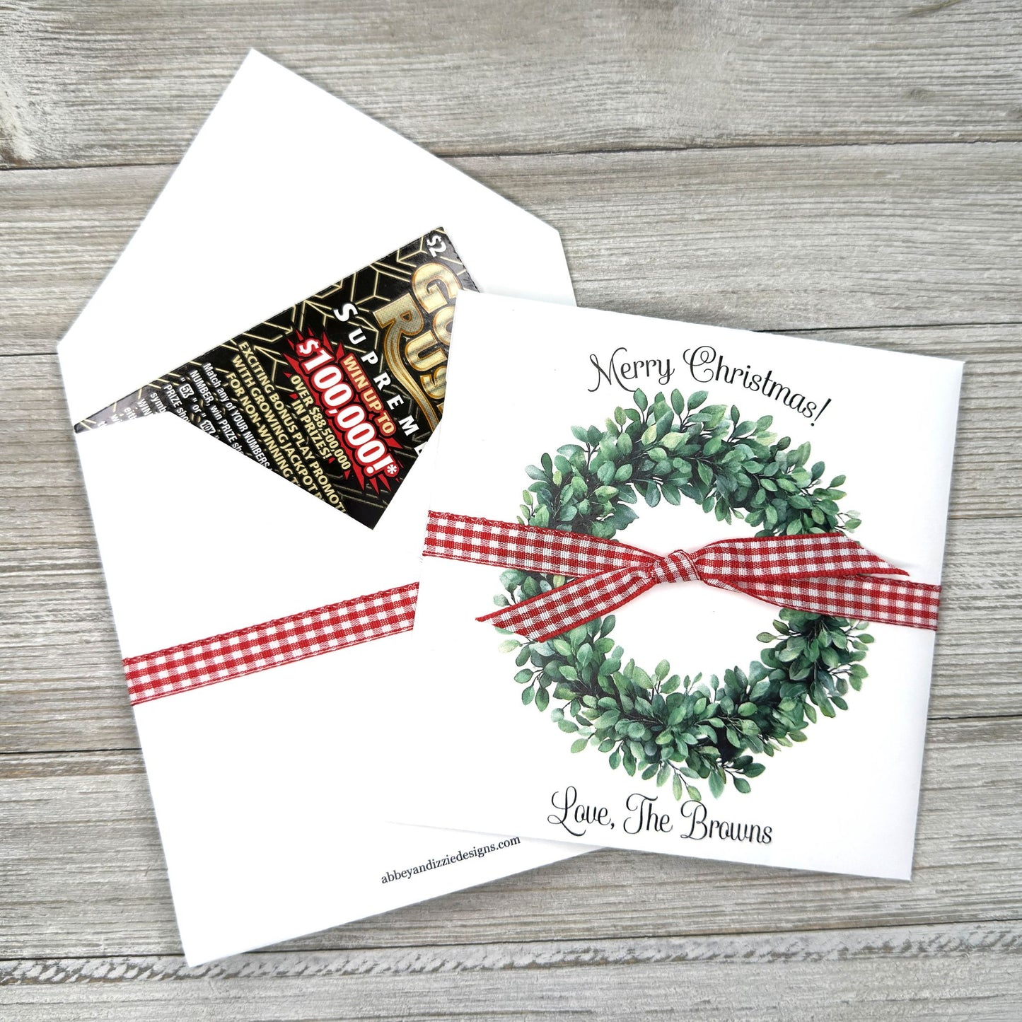 Perfect for holiday gatherings, these personalized gift envelopes add a thoughtful touch for guests, friends or customers. Each 5" × 5" envelope is printed on premium white card stock and arrives fully assembled with ribbon attached ready to slide a lottery ticket or gift card inside. Customize with "Merry Christmas" or "Happy Holidays" and personalize with names or business, your choice of red checked or black checked ribbon.