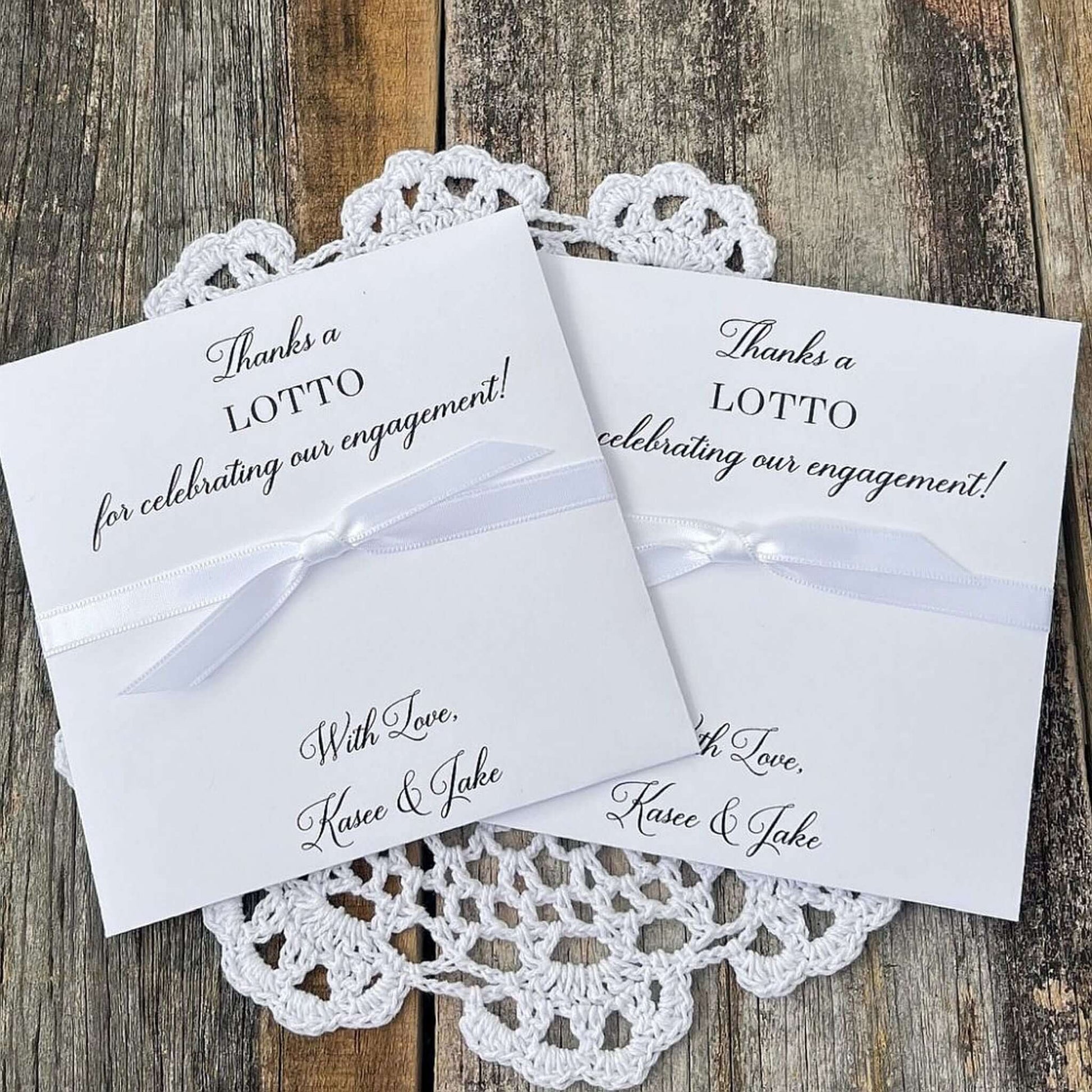 Personalized engagement party favors, slide a lotto ticket in these envelopes to see who wins.  Printed with, thanks a lotto for celebrating our engagement!  with love the happy couple.  White envelopes, your choice of ribbon color which comes attached