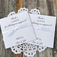 Personalized engagement party favors, slide a lotto ticket in these envelopes to see who wins.  Printed with, thanks a lotto for celebrating our engagement!  with love the happy couple.  White envelopes, your choice of ribbon color which comes attached