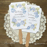 Elevate your wedding ambiance with our personalized blue hydrangea fans, beautifully crafted to complement your special day.  Printed on white card stock with 'welcome to our wedding' and the bride and grooms names with wedding date printed.  Fans ship assembled to you and are two sided, printing on one side only, handle hidden between the layers for a finished look. 