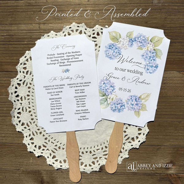 Elevate your wedding ceremony with these elegant blue hydrangea wedding program fans. Designed to keep guests comfortable and informed, each fan features delicate hydrangea artwork in soothing blue tones printed on white card stock.  Fans are two sided with wooden handle hidden between and ship to you assembled.