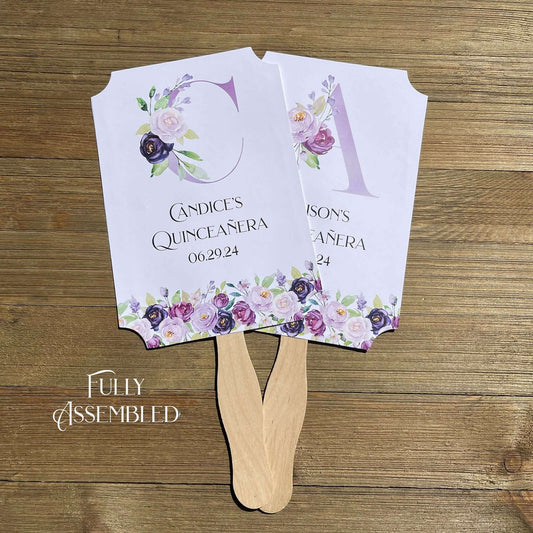 Personalized Quinceanera Favor Fans, Printed on white card stock, purple flowers adorn the bottom with a large floral monogram.  Perfect to keep your guests cool and comortable with a keep sake to take hom