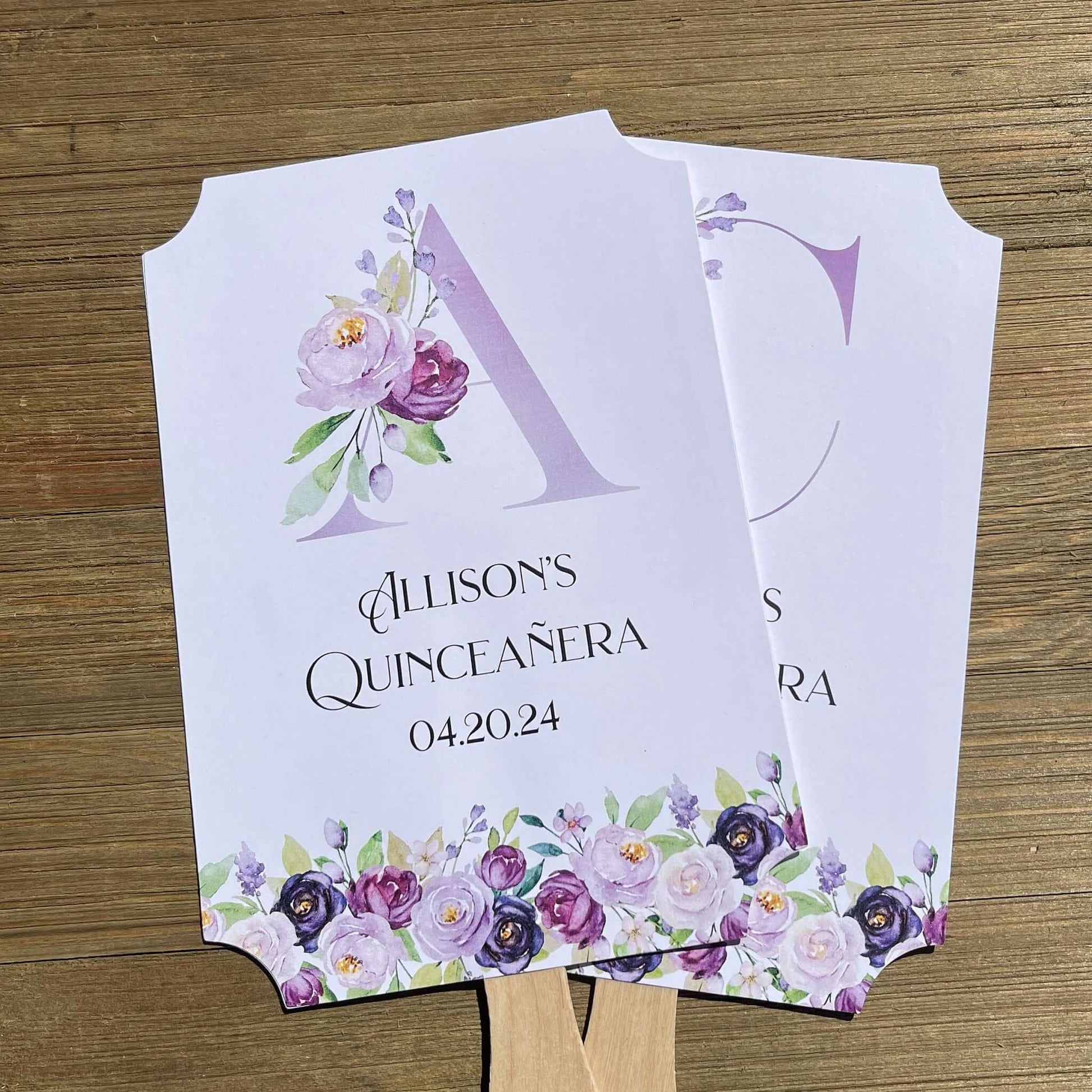 Personalized Quinceanera Favor Fans, Printed on white card stock, purple flowers adorn the bottom with a large floral monogram.  Perfect to keep your guests cool and comortable with a keep sake to take home.