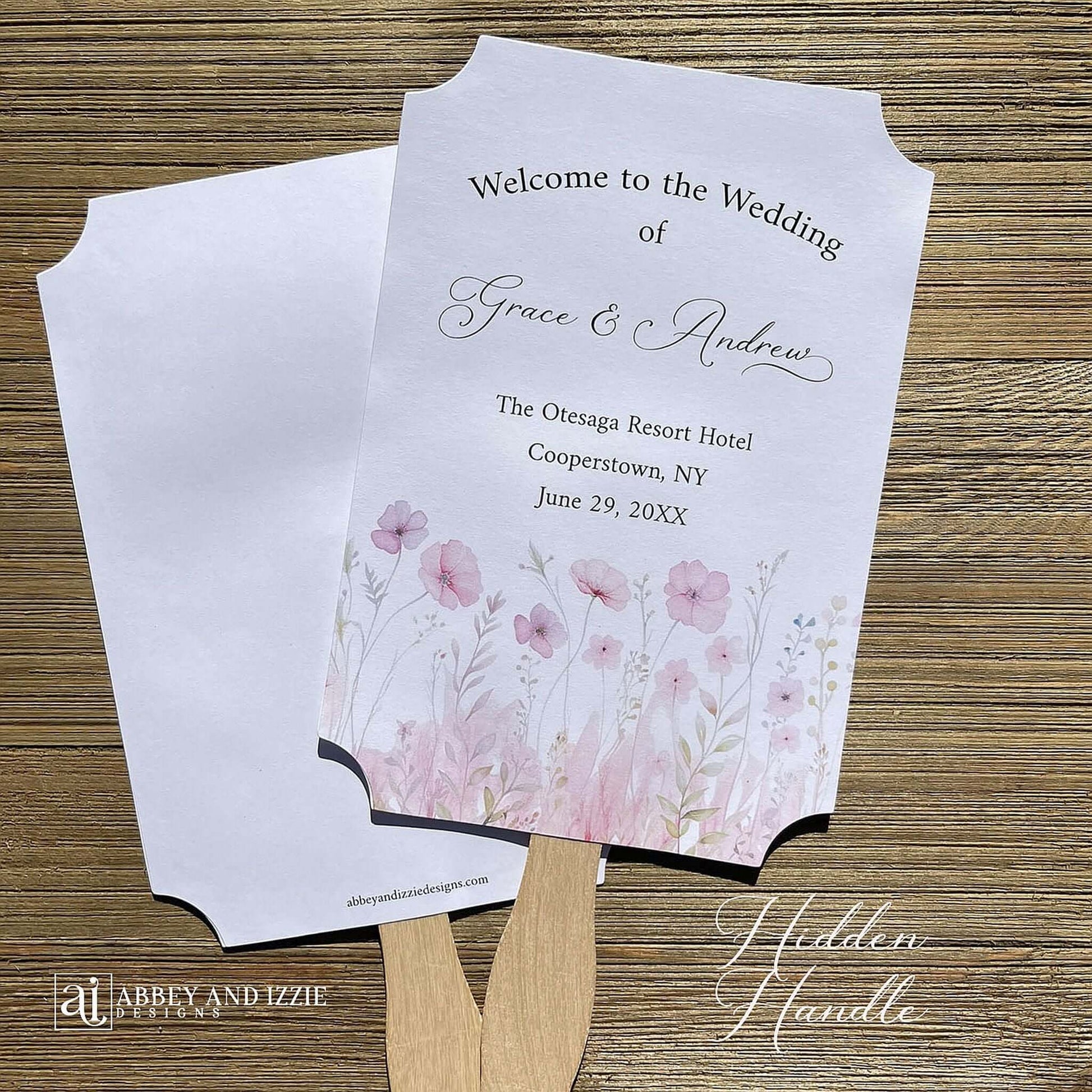 Blush pink wedding fans personalized, printed on white card stock with soft pink flower at the bottom.  Fans are personalized for the bride and groom and includes, place, city, state and date of your wedding.  They arrive fully assembled and ready for your day.
