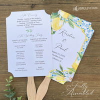 Mediterraanean wedding program fans, adorned with blue tiles and lemons. Printed on white card stock, two sided with handle hidden between. Wedding program on the back on the fans, front is personalized for the bride and groom.