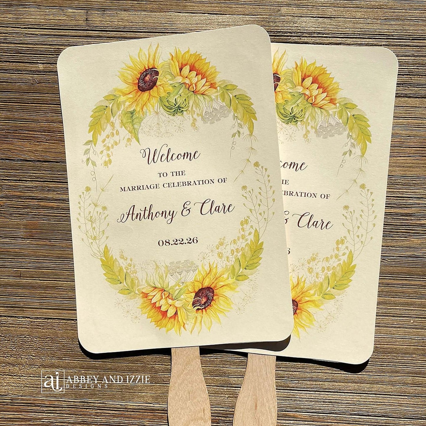 Sunflower Wedding Hand Fans Personalized , personalized for the bride and groom and adorned with a ring of sunflowers.  Fans are printed on ivory cardstock, two sided so handle is hidden between.  Wedding fans ship fully assembled and ready for your big day.
