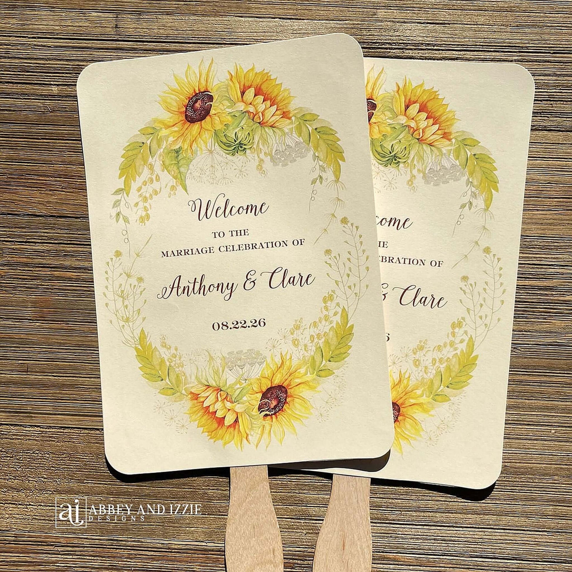 Sunflower Wedding Hand Fans Personalized , personalized for the bride and groom and adorned with a ring of sunflowers.  Fans are printed on ivory cardstock, two sided so handle is hidden between.  Wedding fans ship fully assembled and ready for your big day.