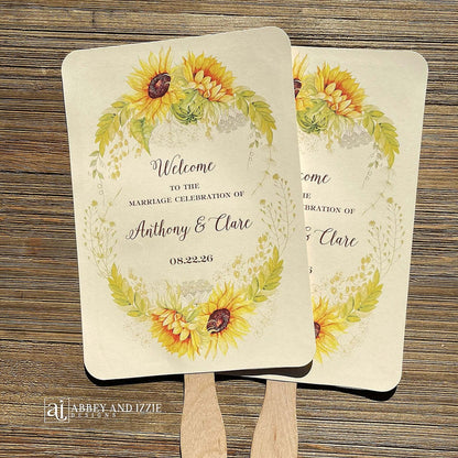 Sunflower Wedding Hand Fans Personalized , personalized for the bride and groom and adorned with a ring of sunflowers.  Fans are printed on ivory cardstock, two sided so handle is hidden between.  Wedding fans ship fully assembled and ready for your big day.