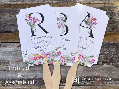 Tropical themed wedding fans monogrammed that are personalized with your large initial, bride and grooms names and wedding date. Adorned with tropical flowers, printed on white card stock. A great keepsake to take home as well as keeping your guests comfortable. Perfect for destination weddings.