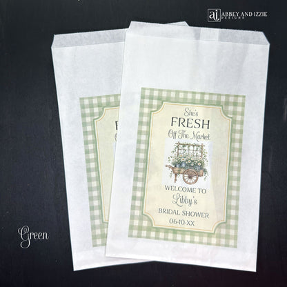 Our "Fresh Off The Market" bridal shower bags are the perfect keepsake for guests—ideal for holding treats, small gifts, or personalized tokens of appreciation.  Printed on white bags with your choice of blue or green flower carts.  Personalized with the brides name and shower date.