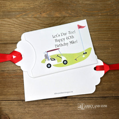 Golf Birthday Party Favors, personalized for the guest of honor, slide a lotto ticket in these envelopes for a fun favor.  White envelopes with red ribbon attahced, with a golf scene printed and Let's Par-Tee!  Happy Birthday to the guest of honor.