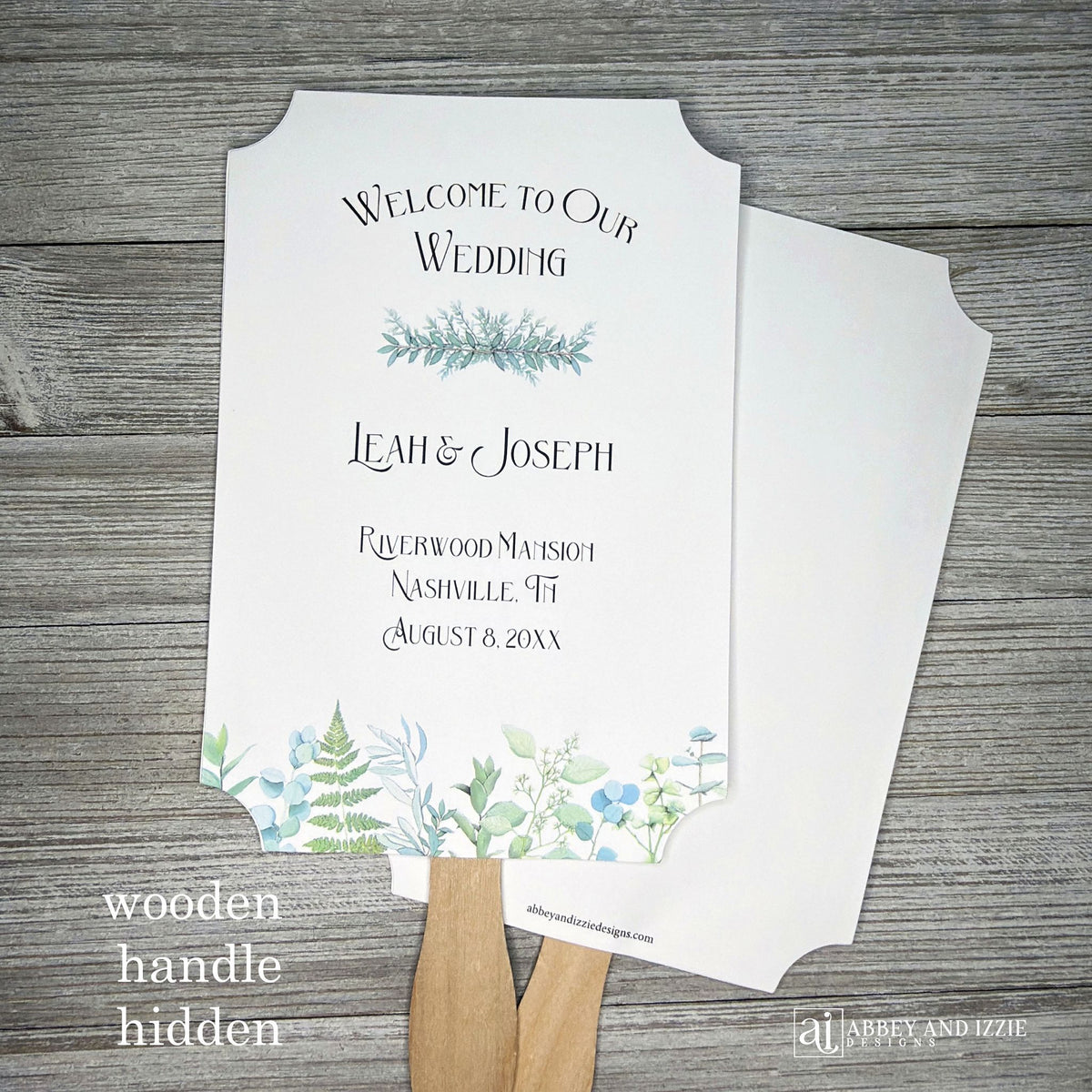 Greenery Wedding Favor Fans personalized and shipped assembled.  White fans with  bride and grooms names, date and wedding location.  Delicate greenery printed at the bottom, corners are cut out, wooden handle is hidden between layers.
