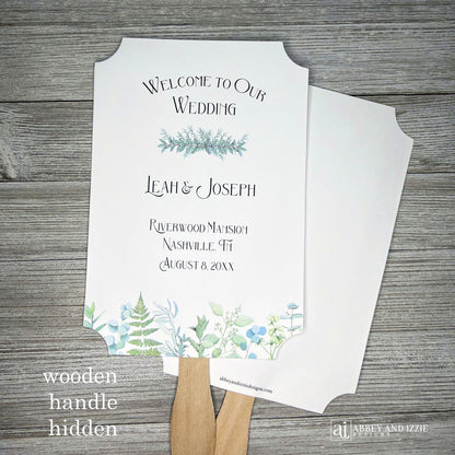 Greenery Wedding Favor Fans personalized and shipped assembled.  White fans with  bride and grooms names, date and wedding location.  Delicate greenery printed at the bottom, corners are cut out, wooden handle is hidden between layers.