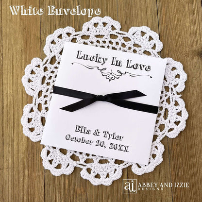 Rustic Wedding Guest Favors, printed with 'Lucky In Love' and the bride and groom with wedding date. Large envelopes, easy to add a scratch off lotto ticket for a fun favor. Your choice of envelope and ribbon color.