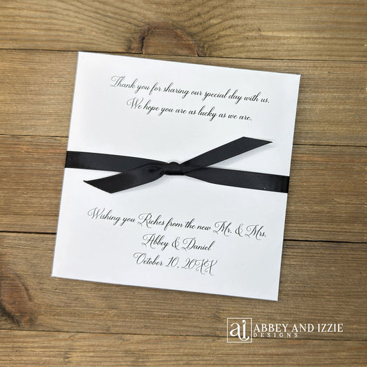 Wishing You Riches wedding favors personalized with a special message to your guests. Our lottery ticket envelopes come fully assembled, printed on white cardstock with ribbon attached, your choice of&nbsp; ribbon colors to match your wedding theme. Wedding guest favors measure 5" x 5", plenty of room for a scratch off lotto ticket or the perfect size to slide in a custom coaster. Lottery tickets are not included with your purchase of our Wishing You Riches Wedding Favors Personalized.