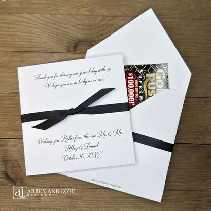 Wishing You Riches wedding favors personalized with a special message to your guests. Our lottery ticket envelopes come fully assembled, printed on white cardstock with ribbon attached, your choice of ribbon colors to match your wedding theme. Wedding guest favors measure 5" x 5", plenty of room for a scratch off lotto ticket or the perfect size to slide in a custom coaster. Lottery tickets are not included with your purchase of our Wishing You Riches Wedding Favors Personalized.
