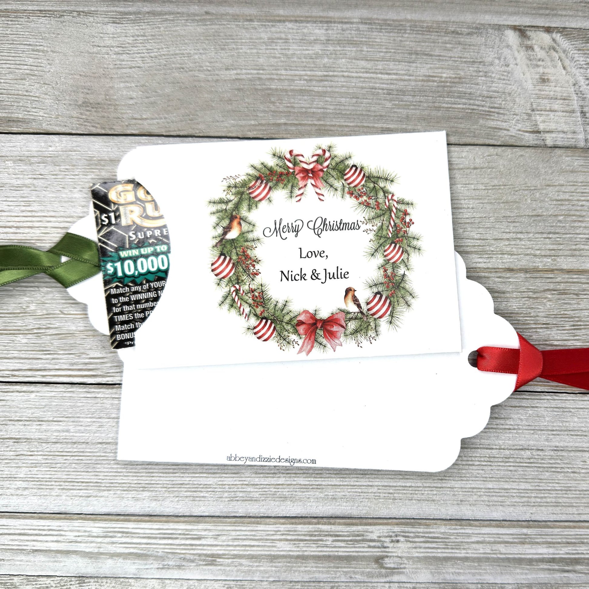 Personalized Christmas Party Favors Affordable Christmas Gifts, adorned with a beautiful wreath and a red  or green ribbon attached.  These can be used for lottery ticket favors or gift card holders.