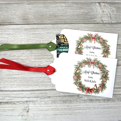 Personalized Christmas Party Favors Affordable Christmas Gifts, adorned with a beautiful wreath and a red  or green ribbon attached.  These can be used for lottery ticket favors or gift card holders.