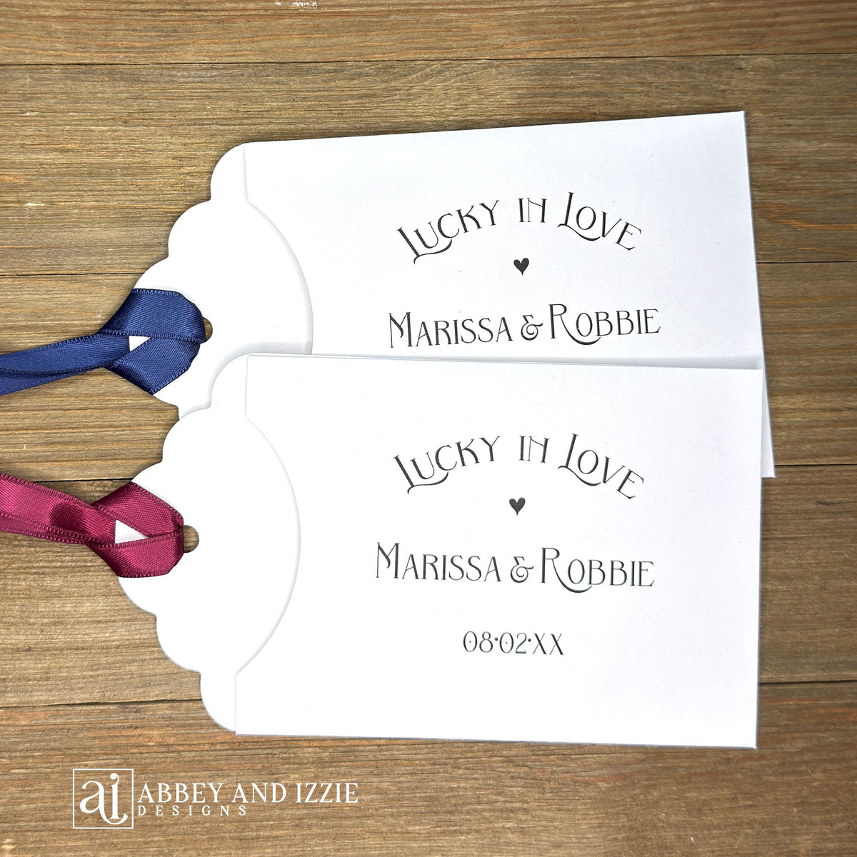 Lucky In Love Wedding Lotto Favors, personalized for the bride and groom.  Slide a lottery ticket these adorable envelopes for a fun wedding favor.  rinted on white cardstock with your choice of ribbon color.  