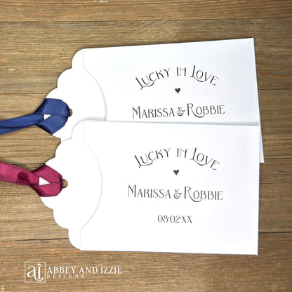 Lucky In Love Wedding Lotto Favors, personalized for the bride and groom.  Slide a lottery ticket these adorable envelopes for a fun wedding favor.  rinted on white cardstock with your choice of ribbon color.  
