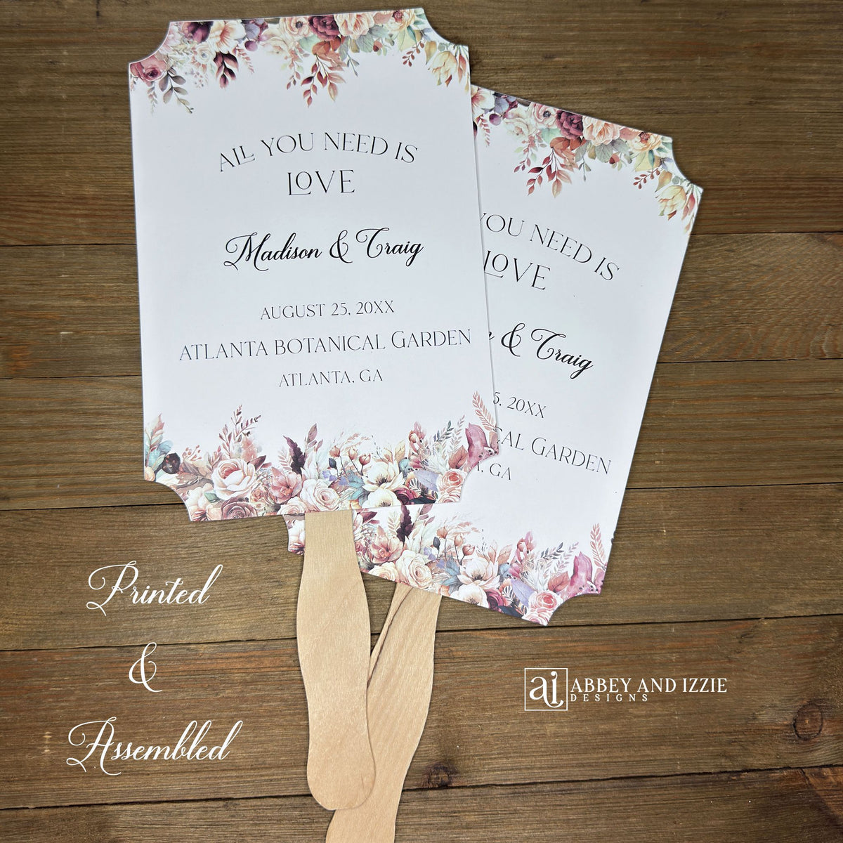 Mocha wedding fans, printed on white card stock with mocha flowers flowing from the top and bottom.  Personalized fans, wooden handle hidden between the two layers of cardstock, shipped assembled.