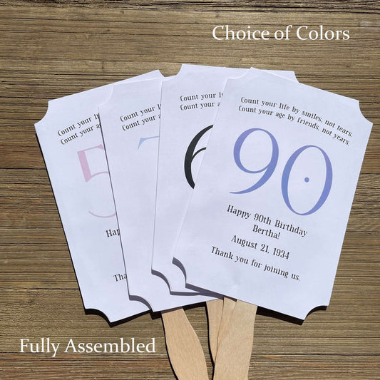 Milestone Birthday Party Favor Fans, keep your guests cool with our fans, perfect keepsake to take home from the party.  Adorned with the large birthday number with the name and birth date of the guest of honor.  Printed on white card stock with your choice of color number.