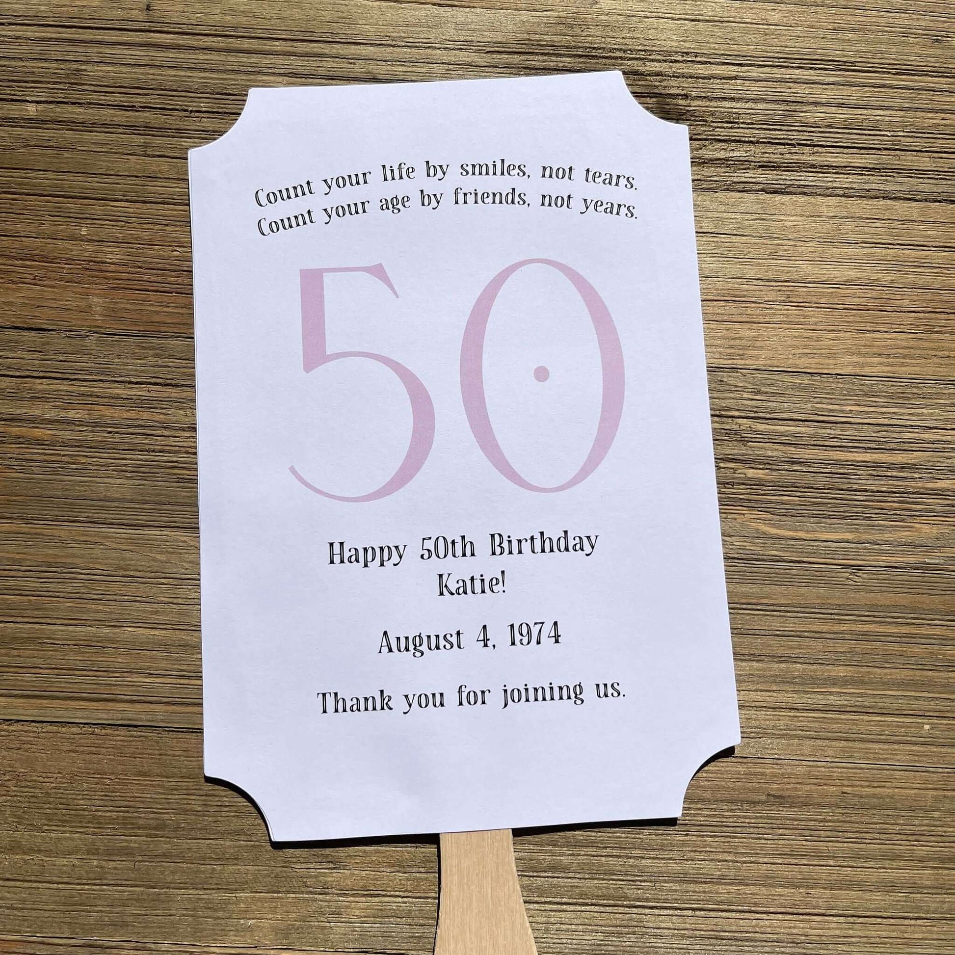 Milestone Birthday Party Favor Fans, keep your guests cool with our fans, perfect keepsake to take home from the party.  Adorned with the large birthday number with the name and birth date of the guest of honor.  Printed on white card stock with your choice of color number.