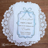 Personalized first birthday party favor bags, 'one is sweet, enjoy a treat, thank you for making my day complete'.  Printed on white paper bags and adorneed with a blue bow and border these will add a touch of elegance to the treat table. 