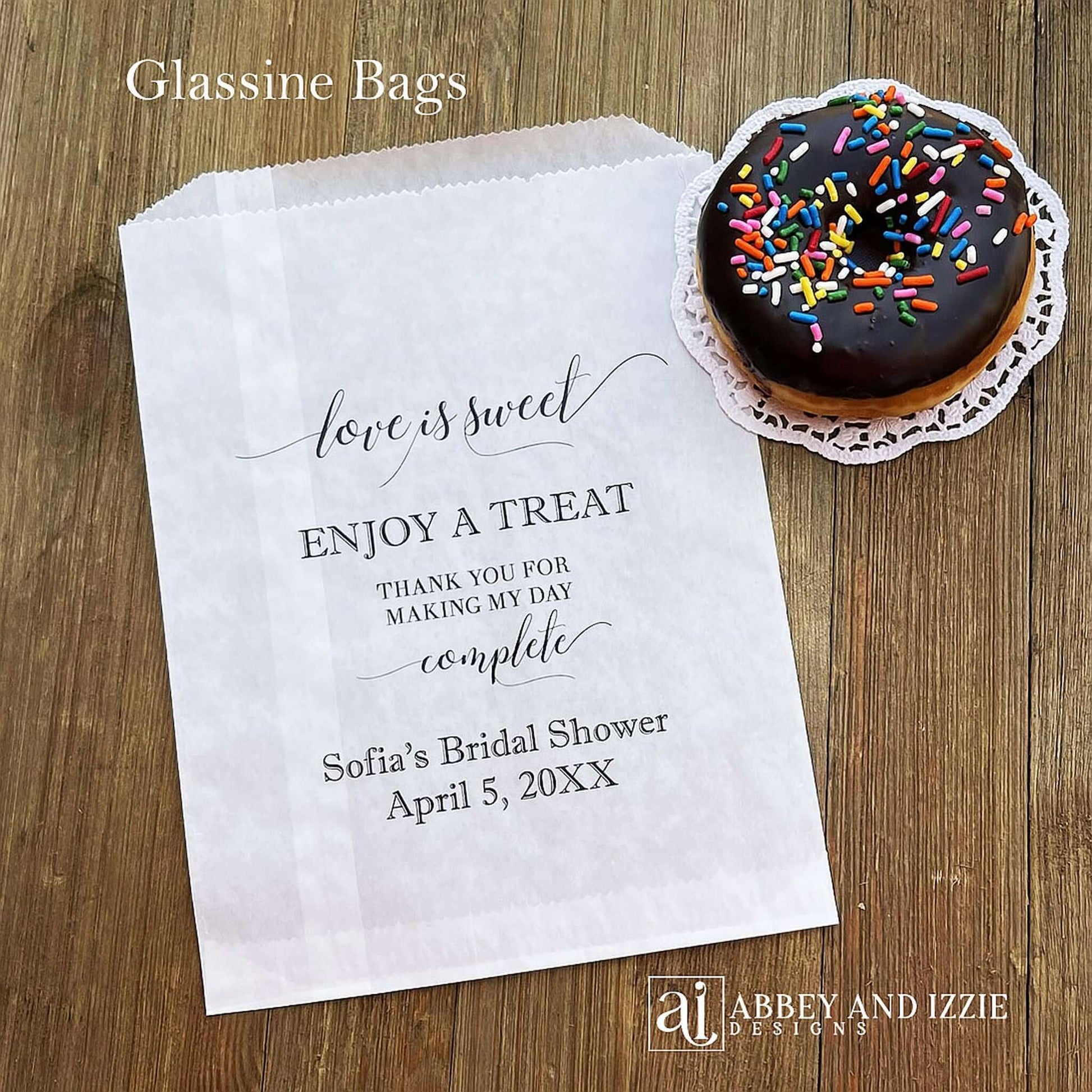 Our personalized glassine bridal shower favor bags are perfect for a candy bar, cookie bar, donut bar or brownies.  Each translucent bag comes printed with 'love is sweet enjoy a treat thank you for making my day complete.'  Personalized with the brides name and event date.  Bags are glassine and grease resistant.
