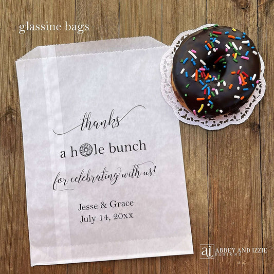 Our personalized wedding donut bags will add a special touch to your donut bar.  Each bag is printed 'thanks a hole bunch for celebrating with us!' with the bride and grooms name and wedding date.  Bags are glassine and grease resistant.  Also great for donut walls.
