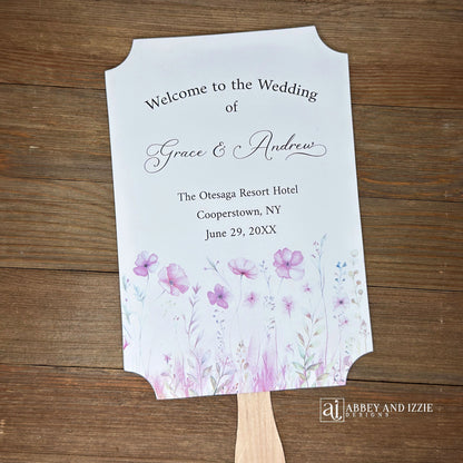 Blush pink wedding fans personalized, printed on white card stock with soft pink flower at the bottom.  Fans are personalized for the bride and groom and includes, place, city, state and date of your wedding.  They arrive fully assembled and ready for your day.