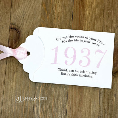 Personalized scratch-off birthday favors for adults. Each envelope features a special message with the year the guest of honor was born in color. Including a thank you for celebrating with the us. Works for milestone birthdays, adult parties, and special events see our store for more options. Constructed from white high-quality cardstock with your choice of year color and ribbon color, which comes attached.