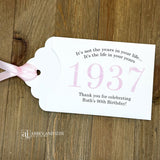 Personalized scratch-off birthday favors for adults. Each envelope features a special message with the year the guest of honor was born in color. Including a thank you for celebrating with the us. Works for milestone birthdays, adult parties, and special events see our store for more options. Constructed from white high-quality cardstock with your choice of year color and ribbon color, which comes attached.
