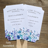 Wedding fans adorned with lavender flowers printed on white card stock.  Personalized for the bride and groom including the place and wedding date.  Fans come fully assembled, two sided with handle hidden between.  A great keepsake while keeping guests cool and comfortable.