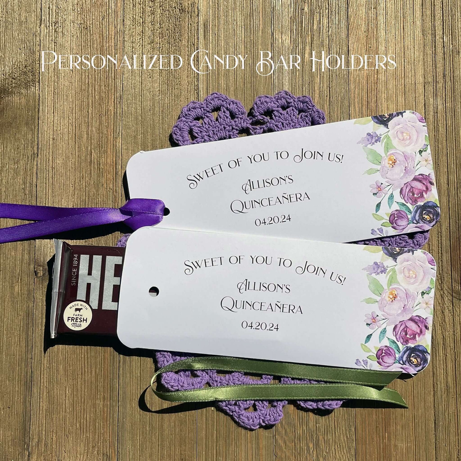 Personalized Quinceanera Candy Favors printed on white card stock and adonred with purple flowers.  Each printed with 'sweet of you to join us' with the guest of honors name and event date.  Slide a candy bar in the open end and tie the ribbon on, your choice of purple or moss green ribbon.