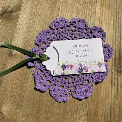 Purple Quninceanera Favors Personalized, slide a scratch off lotto ticket in the envelope and see who wins big.  Envelopes are white adorned with purple flowers and personalized for the guest of honor.  Purple or moss green ribbon comes attached.