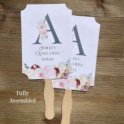 Personalized Quinceanera Monogrammed Fans.  Fans are printed on white card stock and come fully assembled, adorned with a large initial and pink and burgundy flowers for an elegant touch.