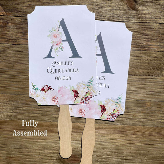 Personalized Quinceanera Monogrammed Fans.  Fans are printed on white card stock and come fully assembled, adorned with a large initial and pink and burgundy flowers for an elegant touch.