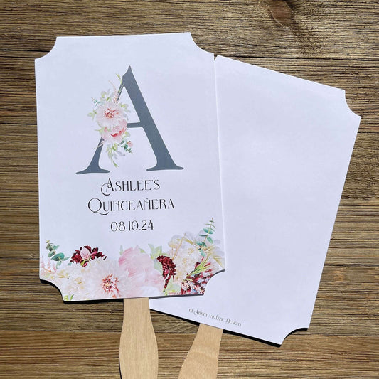 Personalized Quinceanera Monogrammed Fans.  Fans are printed on white card stock and come fully assembled, adorned with a large initial and pink and burgundy flowers for an elegant touch.