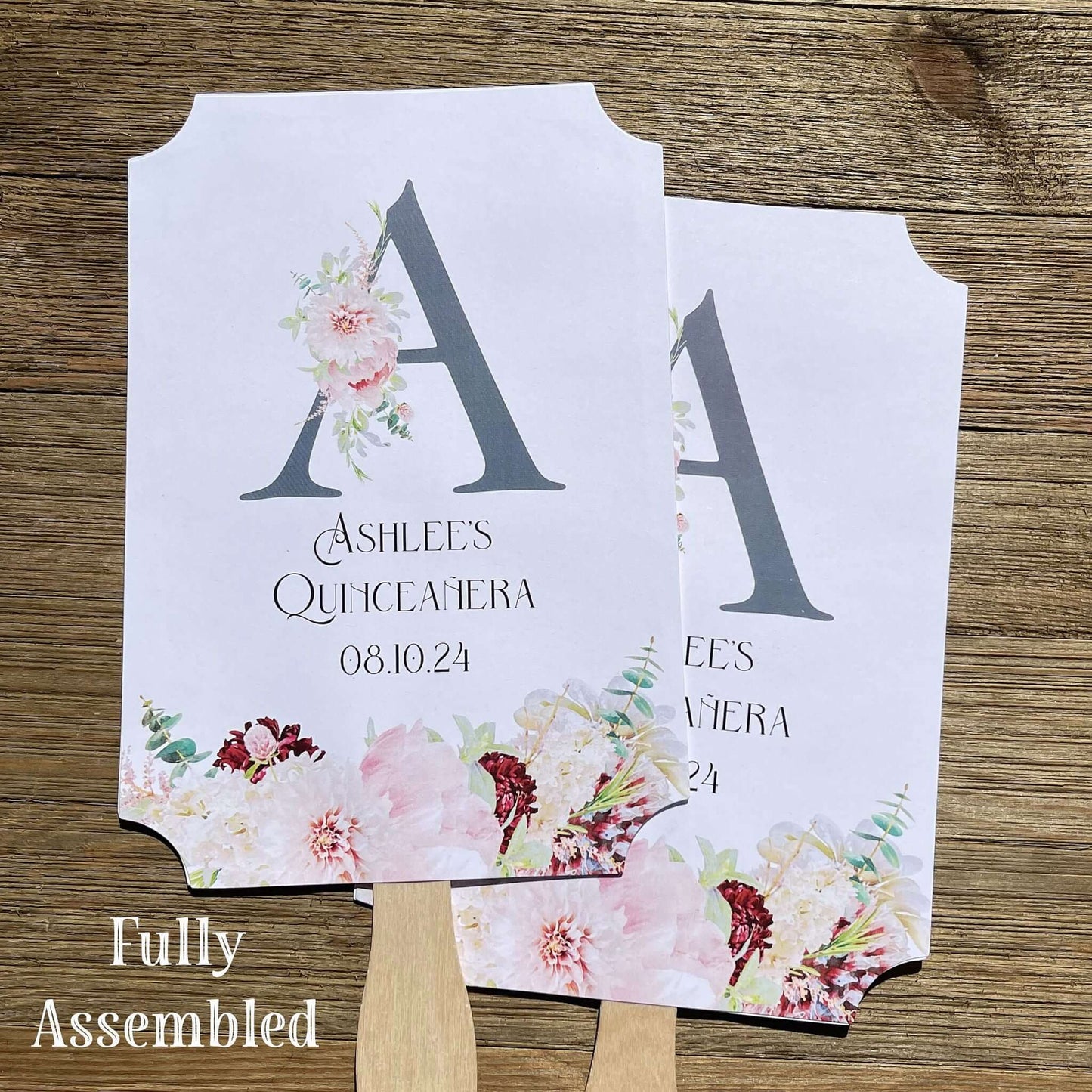 Personalized Quinceanera Monogrammed Fans.  Fans are printed on white card stock and come fully assembled, adorned with a large initial and pink and burgundy flowers for an elegant touch.