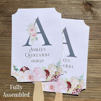 Personalized Quinceanera Monogrammed Fans.  Fans are printed on white card stock and come fully assembled, adorned with a large initial and pink and burgundy flowers for an elegant touch.