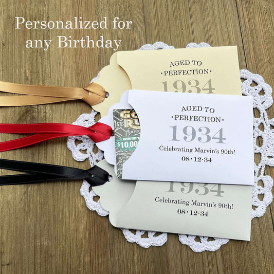 Aged to perfection Party Favors for 90th Birthday.  These fun and easy birthday favors are sure to be a hit with your guests.  Slide a instant lotto ticket in the open end of the envelope and see who wins.  Your choice of envelope and ribbon color, personalized for any birthday.