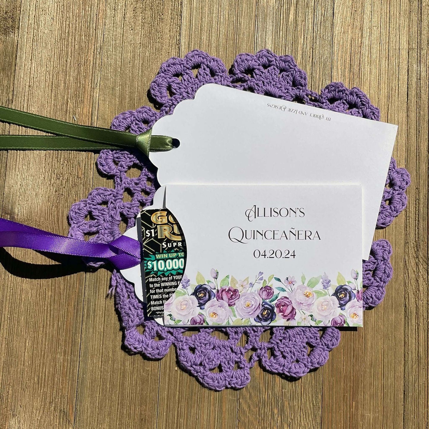 Purple Quninceanera Favors Personalized, slide a scratch off lotto ticket in the envelope and see who wins big.  Envelopes are white adorned with purple flowers and personalized for the guest of honor.  Purple or moss green ribbon comes attached.
