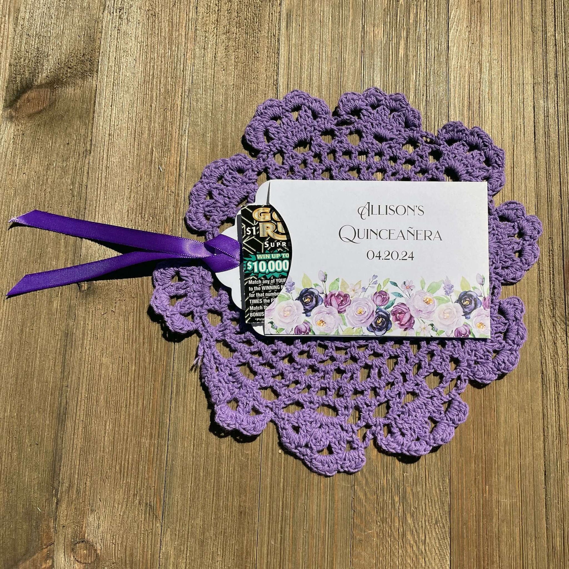 Purple Quninceanera Favors Personalized, slide a scratch off lotto ticket in the envelope and see who wins big.  Envelopes are white adorned with purple flowers and personalized for the guest of honor.  Purple or moss green ribbon comes attached.