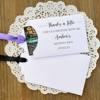 Lottery ticket envelopes for an adult birthday party favor.  Printed 'thanks a lotto for celebrating with me' with the guest of honros name and party date.  Slide a lotto ticket in to see who wins.  Printed on white card stock, your choice of ribbon color.